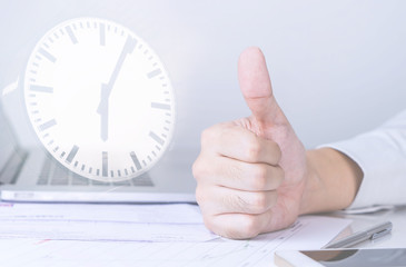 Business man is thumb up for finishing work on time
