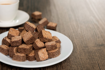 Chocolate Wafers and Coffee on white plate.