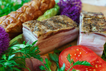 Salted traditional way of pieces of pork, along with chili and vegetables.