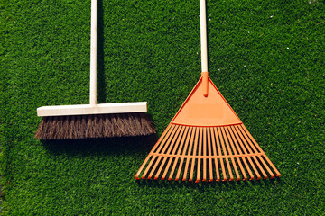 brush and broom on a green grass