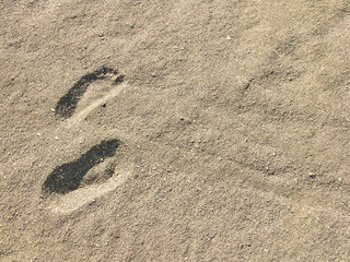 Fototapeta na wymiar Footsteps on the beach by the sea in summer