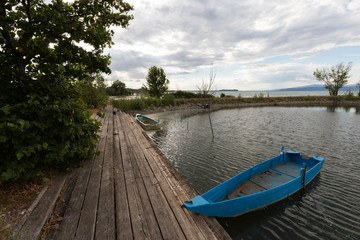 A little, blue fishing boat in a small harbour