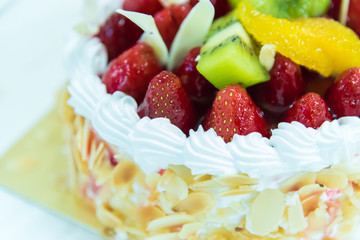 Strawberry cake with kiwi and almond in white plate with closeup view has ready to served in the dessert time.