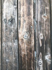 Pattern of Gray-brown vertical wood panel.