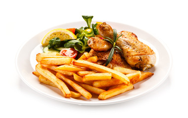 Roast chicken leg with french fries on white background 