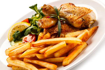 Roast chicken leg with french fries on white background 
