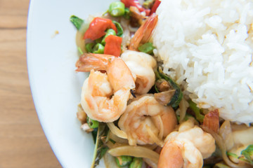 Stir-Fried Shrimps and Basil Rice Thai Food style has ready to served on white plate.