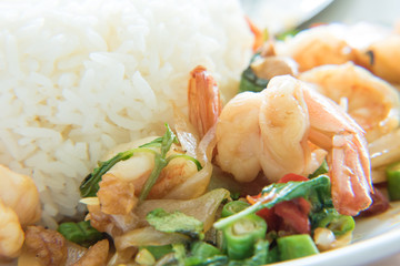 Stir-Fried Shrimps and Basil Rice Thai Food style has ready to served on white plate.
