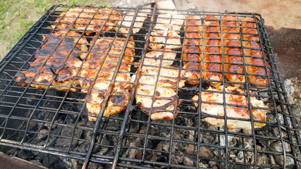 Cooking juicy and delicious pork, beef and chicken in the grill during summer vacation