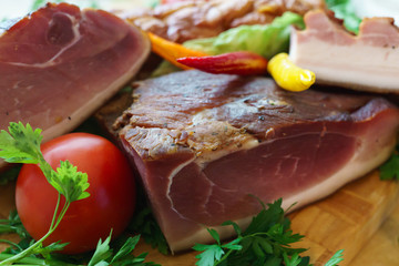 Salted traditional way of pieces of pork, along with chili and vegetables.