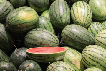 Watermelon and cutting fruit in supermarket.