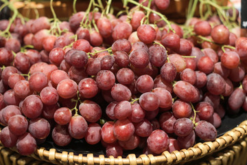 Red grapes in the basket for selling in supermarket.