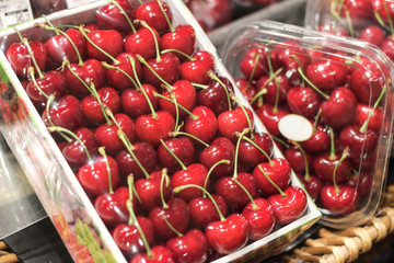 Red cherry in the box cover whith plastic in supermarket.