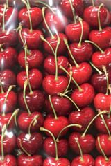 Red cherry in the box cover whith plastic in supermarket.