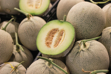 Melon and cutting fruit in supermarket.