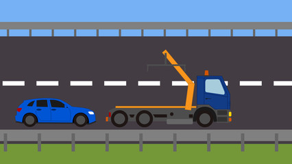 Tow truck picking up a vehicle on the road