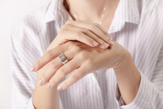 Close up image of crossed female hands