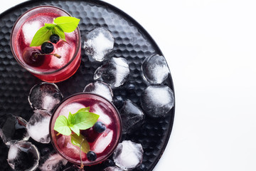 Red drink with basil and berries top view. © ytochka89