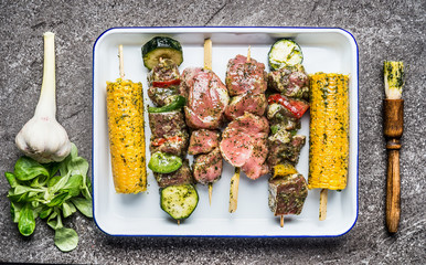 Tasty meat, vegetables and corn skewers in herbs marinate with fresh seasoning and Basting Brush for grilling, top view