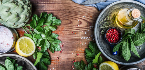 Obraz na płótnie Canvas Healthy eating and cooking with fresh organic ingredients. Herbs,spices and olives oil on rustic wooden background, top view, banner