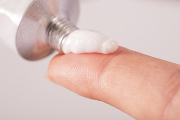 Close up image of hands with cream tube