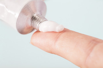 Fototapeta na wymiar Close up image of hands with cream tube