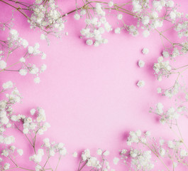 Fototapeta premium Lovely Little white Gypsophila flowers on pink background, pretty floral frame, top view, copy space, square