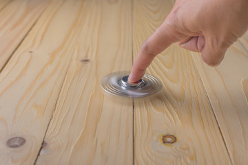hand with spinner on table.