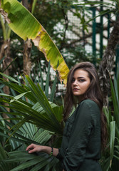 Beauty Romantic Girl Outdoor. Beautiful Teenage Model Dressed in Fashionable Green Dress Posing Outdoors in park.