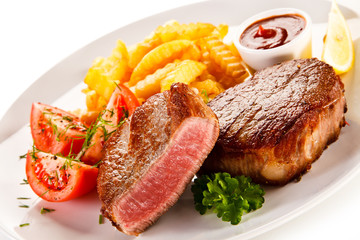 Grilled beefsteak with french fries on white background 