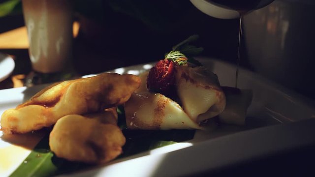 Pouring syrup on pisang goreng and dadar gulung, slide