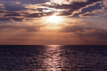 Naklejka premium Sunset (dawn) of the sun and sunbeams over the sea (ocean). Summer sea background.