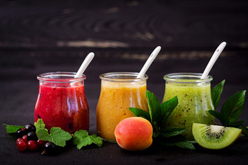 Fresh healthy smoothies from different berries on a dark background. Diet menu. Proper nutrition.
