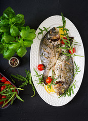 Baked dorado fish  in garlic dill sauce  and lemon.Flat lay.Top view