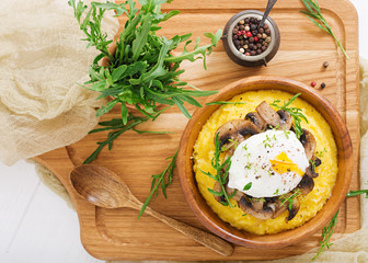 Breakfast. Polenta with mushrooms and poached egg. Flat lay. Top view.