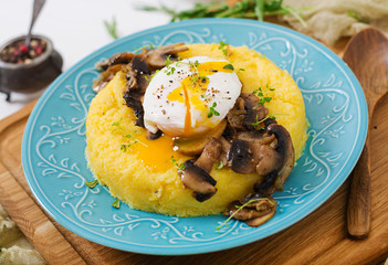 Breakfast. Polenta with mushrooms and poached egg.