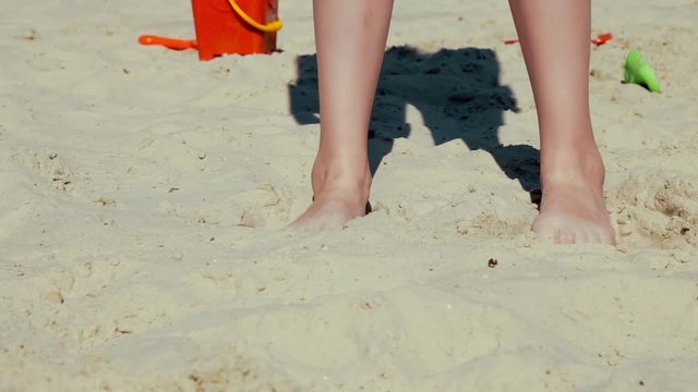 Children play in the sandbox in summer