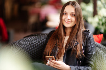 Young pretty girl look at camera and smile, blur background
