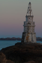 Fototapeta na wymiar Beautiful Sunset at Old lighthouse in the port of Ahtopol, Black sea, Bulgaria