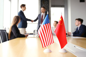 Chinese and American leaders shaking hands on a deal agreement.