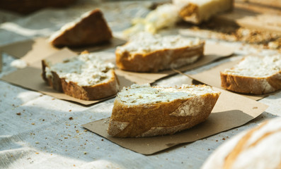 Sliced fresh bread with spread on it, closeup shot, selective focus