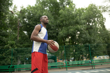 African american man plays on basketball court. Real and authentic activity.