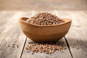 Buckwheat groats in wooden bowl