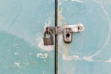 Key lock locked on vintage metal fence. Security Concept.