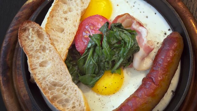 scrambled eggs with sausage and spinach in a skillet