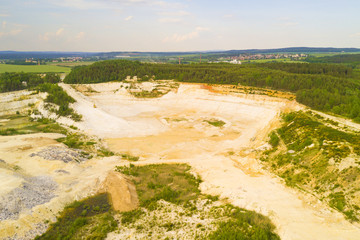 Aerial view of open pit kaolin quarry for ceramic tiles production. Industrial area from above. Chlumcany, Czech republic, European union.