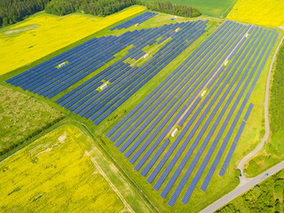 Aerial view of solar power plant. Large solar farm system from drone view. Photovoltaic power station in countryside. Source of ecological renewable energy.