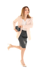 Young businesswoman running on white background