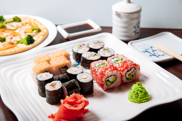 Sushi and rolls on a wooden table.