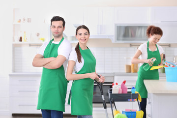 Cleaning service team working in kitchen